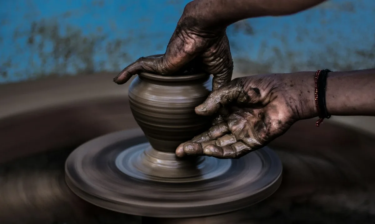 Hands shaping clay; illustrative creative workshop photograph